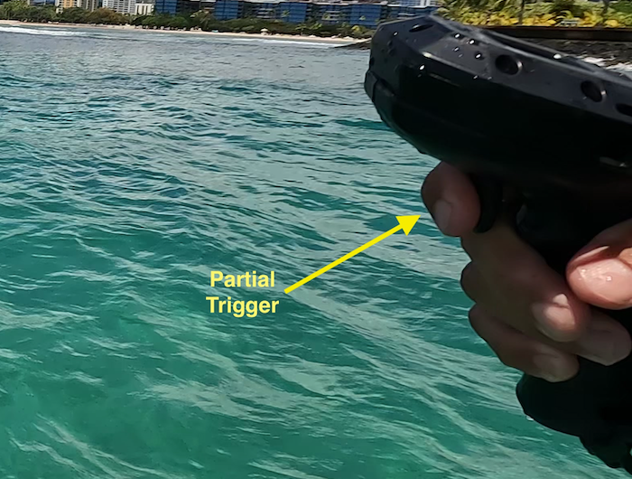 Trigger_partial-2 a person swimming in a body of water